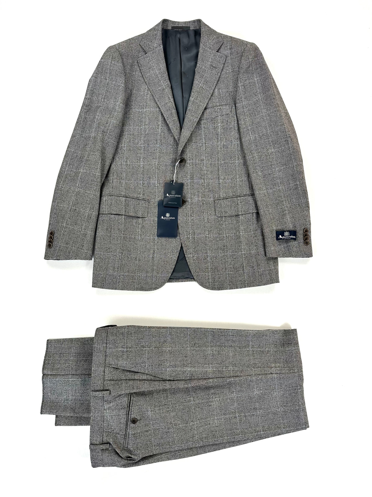 Completo Aquascutum Principe di Galles bianco e nero: giacca e pantalone coordinato distesi su fondo chiaro