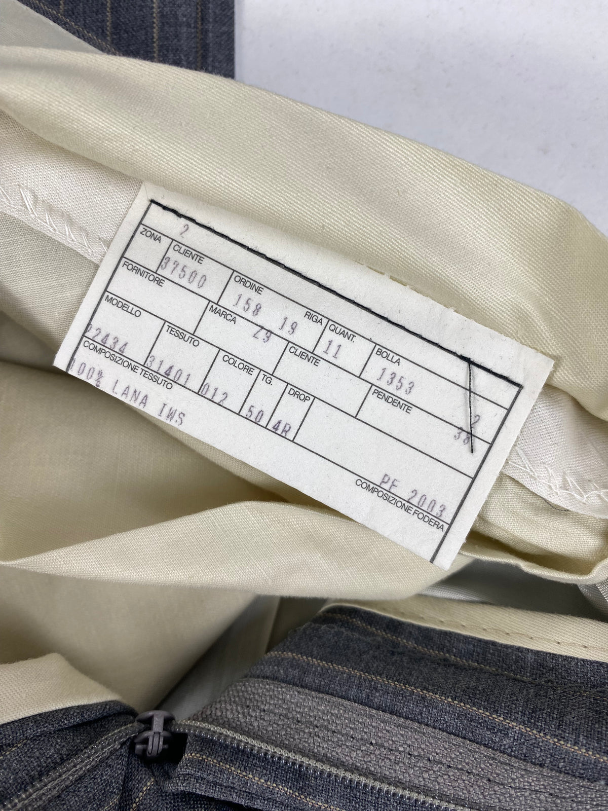 Scheda di commessa del pantalone sulla fodera avorio: 100% lana IWS, taglia 50 drop 4R