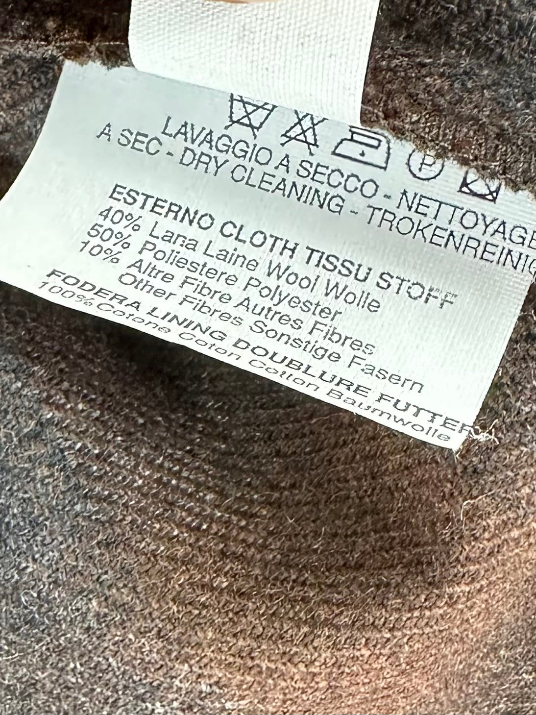 Etichetta composizione Millibar: 40% lana, 50% poliestere, 10% altre fibre, fodera 100% cotone, lavaggio a secco
